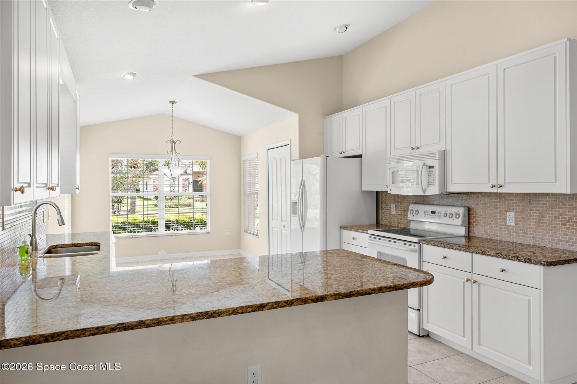 6904 Renshaw Drive Melbourne, FL 32940 - Photo 6 of 46 a kitchen with stainless steel appliances granite countertop a sink stove and refrigerator