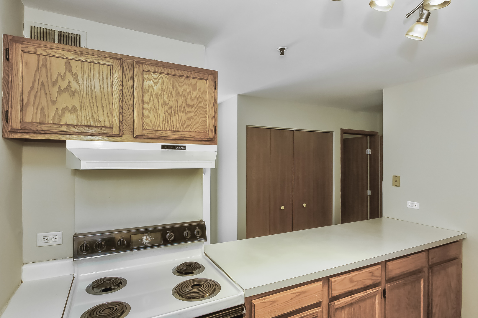 3255 Kirchoff Road, Unit 208 Rolling Meadows, IL 60008 - Photo 11 of 21 a view of kitchen with a sink and wooden cabinets