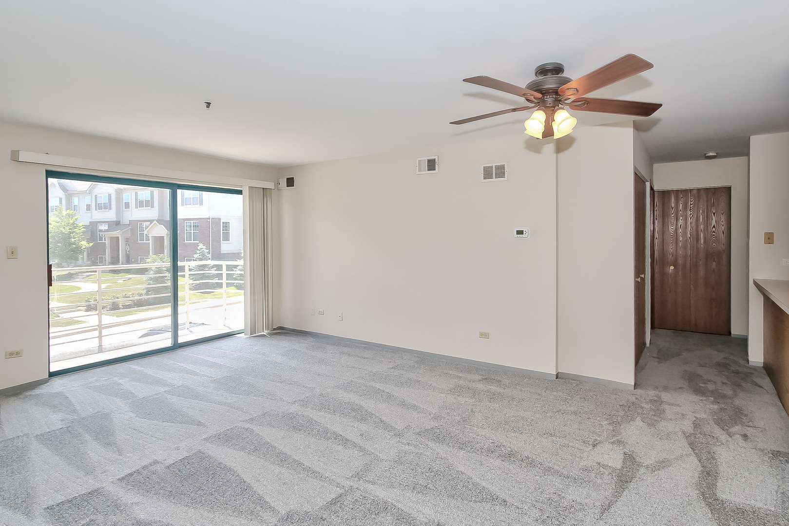 3255 Kirchoff Road, Unit 208 Rolling Meadows, IL 60008 - Photo 7 of 21 a view of an empty room with a window