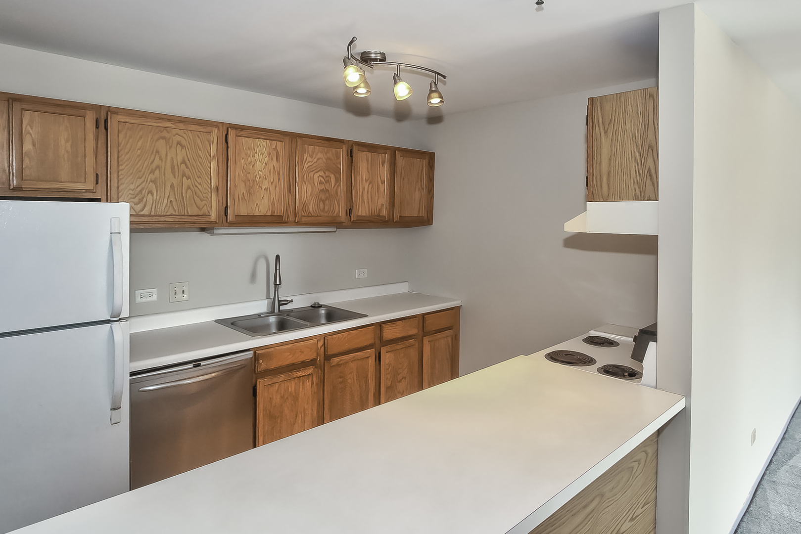 3255 Kirchoff Road, Unit 208 Rolling Meadows, IL 60008 - Photo 8 of 21 a kitchen with a sink a stove and refrigerator
