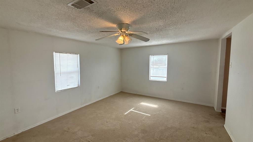 201 East Hubbard Road Josephine, TX 75173 - Photo 14 of 23 an empty room with windows and fan