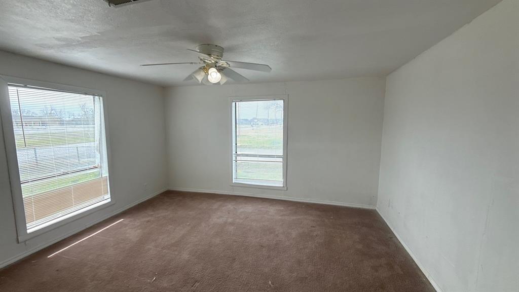 201 East Hubbard Road Josephine, TX 75173 - Photo 18 of 23 an empty room with a window and a fan