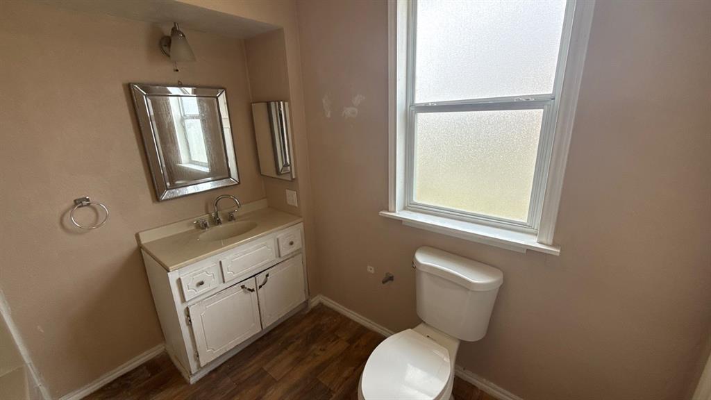 201 East Hubbard Road Josephine, TX 75173 - Photo 19 of 23 a bathroom with a toilet sink and mirror