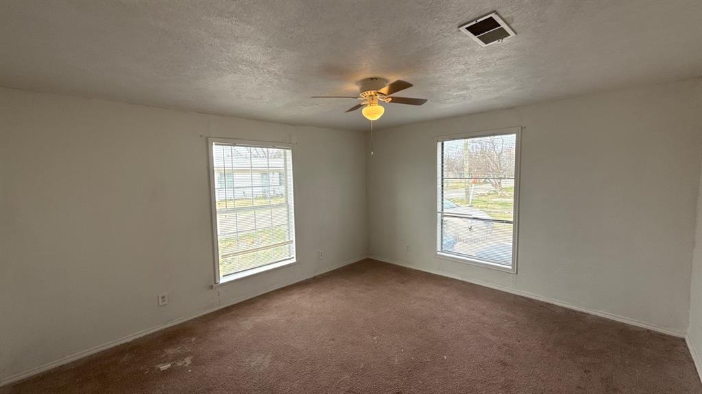 201 East Hubbard Road Josephine, TX 75173 - Photo 20 of 23 an empty room with windows and chandelier fan