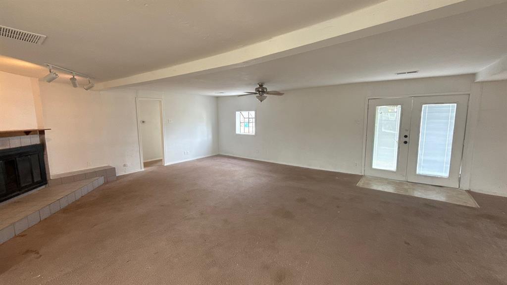 201 East Hubbard Road Josephine, TX 75173 - Photo 4 of 23 a view of a big room with windows and fireplace