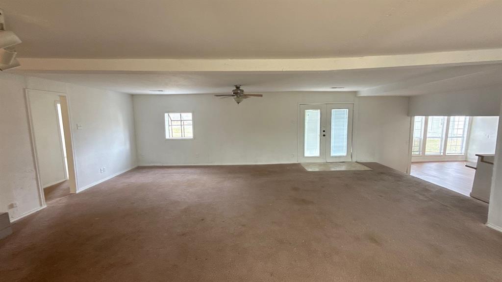 201 East Hubbard Road Josephine, TX 75173 - Photo 8 of 23 a view of a big room with windows and chandelier fan