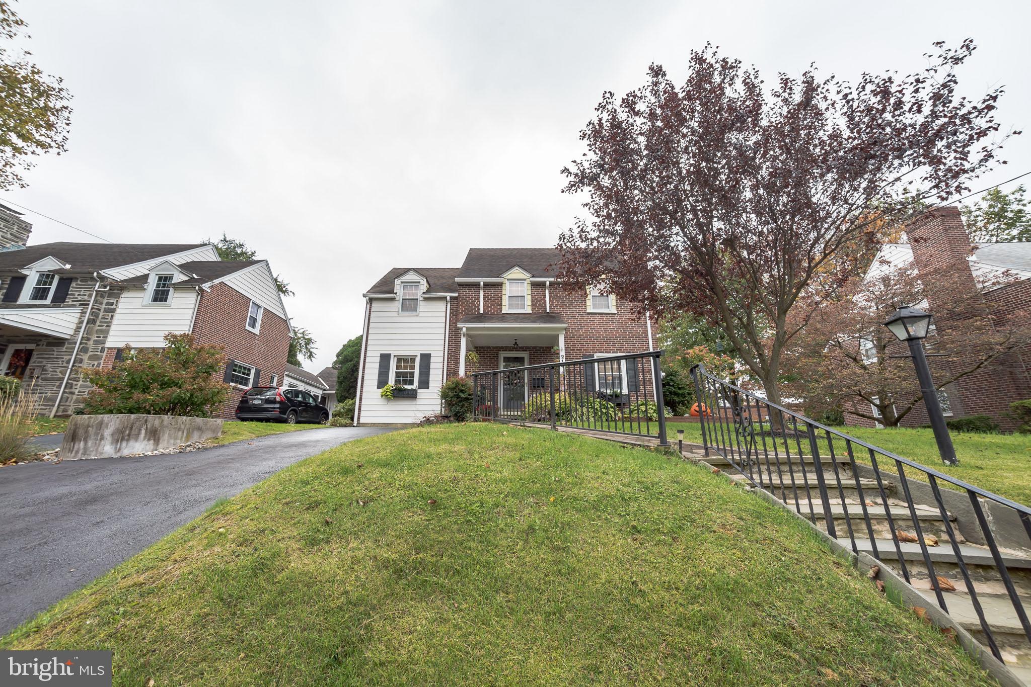 214 Claremont Road Springfield, PA 19064 - Photo 2 of 30 a view of a big house with a big yard and large trees