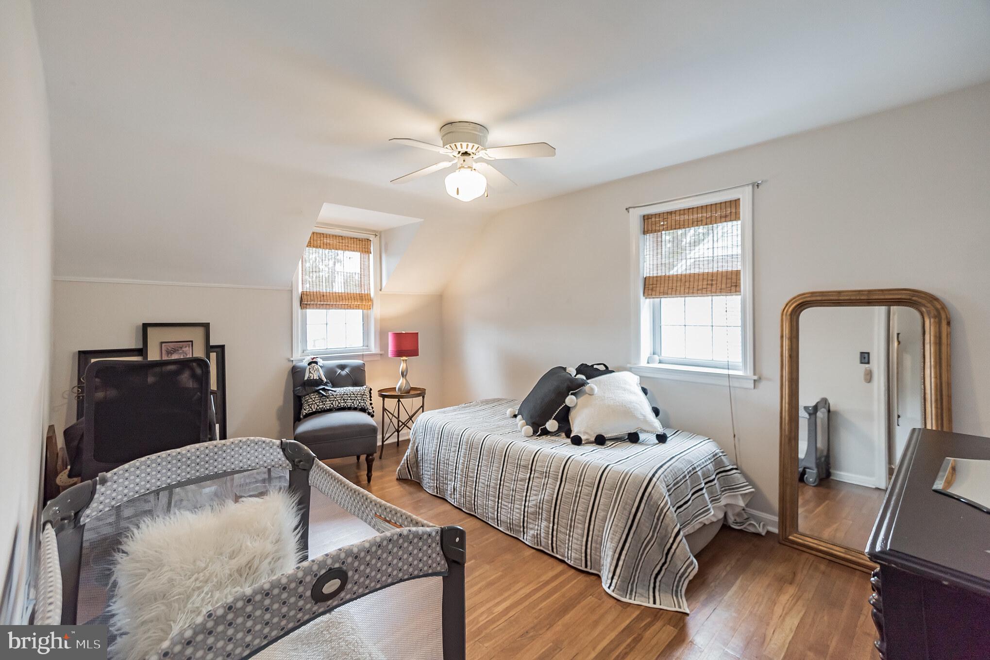 214 Claremont Road Springfield, PA 19064 - Photo 16 of 30 a bedroom with a bed and wooden floor