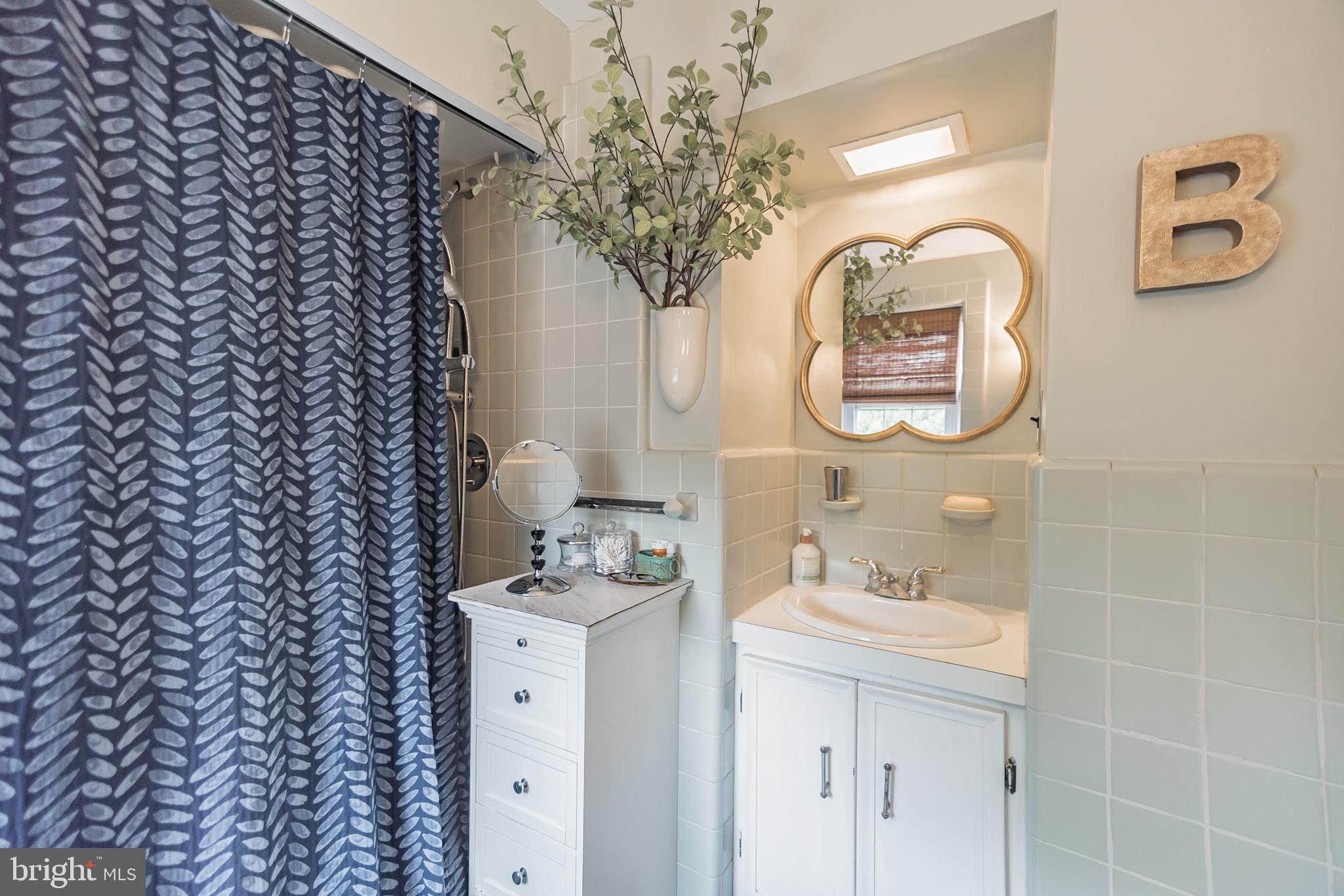 214 Claremont Road Springfield, PA 19064 - Photo 18 of 30 a bathroom with a sink and a mirror