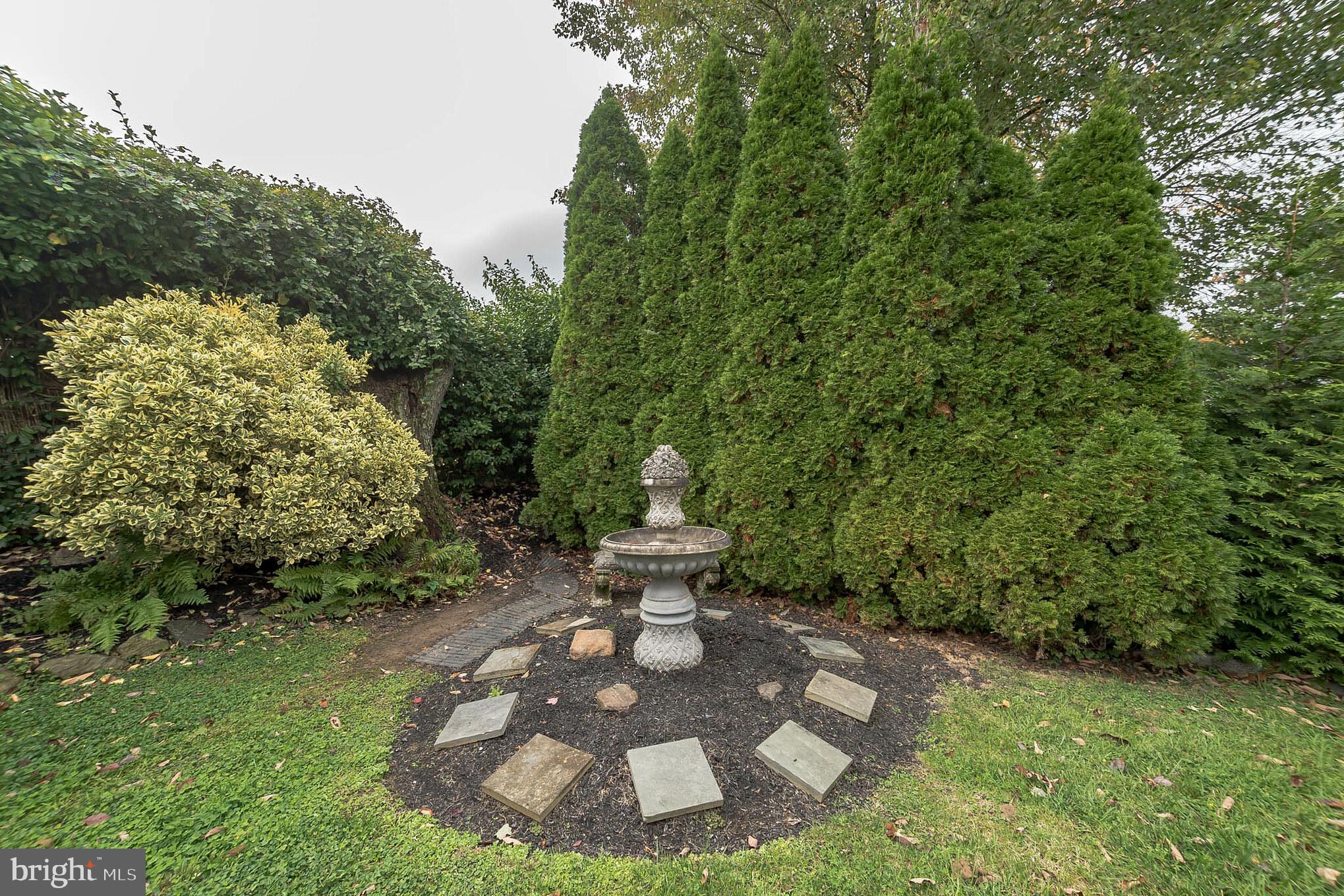 214 Claremont Road Springfield, PA 19064 - Photo 30 of 30 a view of a backyard with fountain plants and large tree