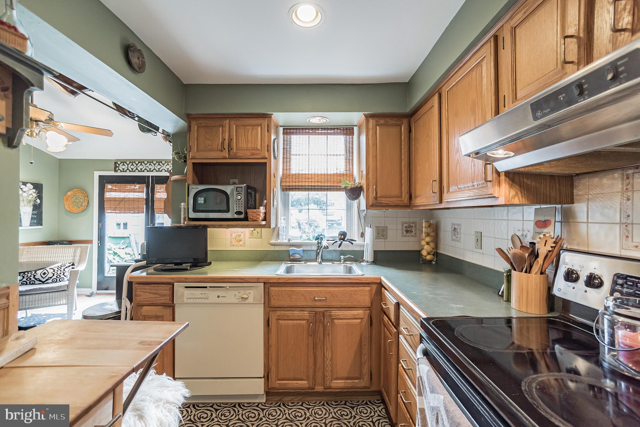 214 Claremont Road Springfield, PA 19064 - Photo 10 of 30 a kitchen with stainless steel appliances granite countertop a sink stove and cabinets