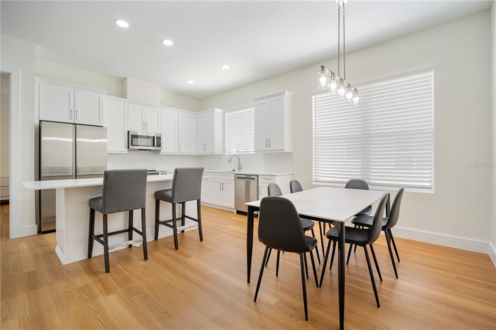 13614 North 22nd Street Tampa, FL 33613 - Photo 12 of 30 a view of a dining room with furniture and wooden floor