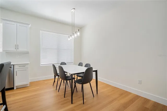 a view of a dining room with furniture window and wooden floor