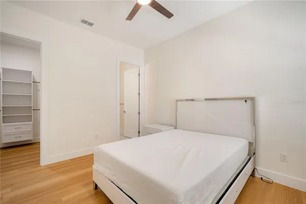 a large white bed in a white room
