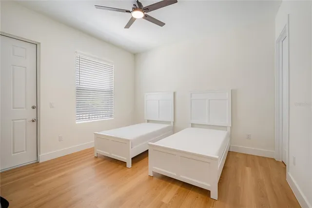 a spacious bedroom with a bed and a window