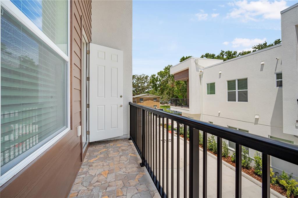 13614 North 22nd Street Tampa, FL 33613 - Photo 25 of 30 a view of a house with a balcony