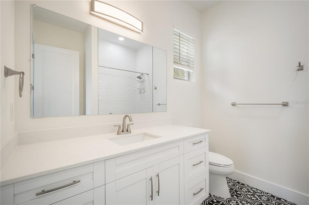 13614 North 22nd Street Tampa, FL 33613 - Photo 27 of 30 a bathroom with a sink a toilet and a mirror