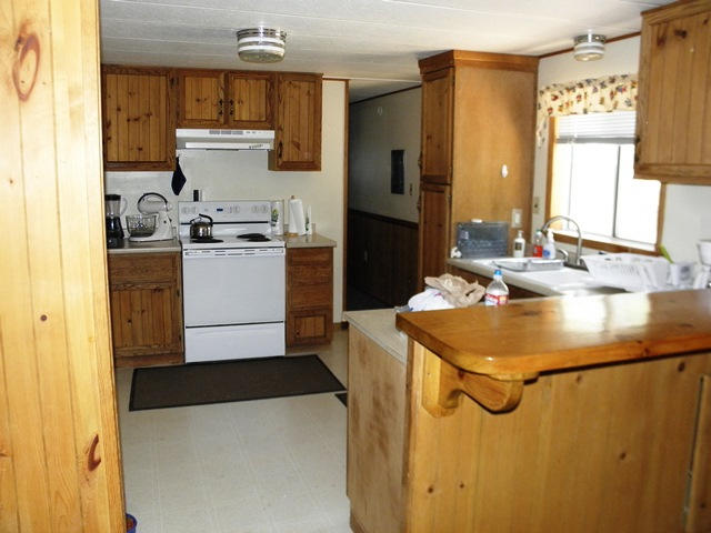 3322 Rim Lakes Drive Overgaard, AZ 85933 - Photo 23 of 36 a kitchen with a sink a stove and a refrigerator