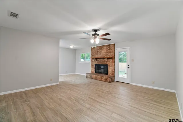 a view of an empty room with a fireplace