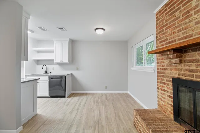 a kitchen with a refrigerator and a stove top oven