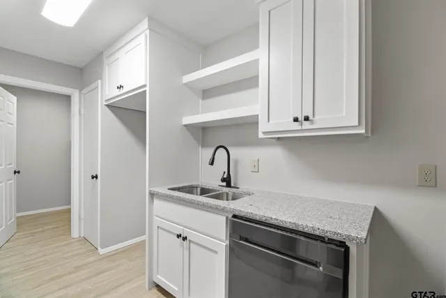 a view of a sink and cabinets in kitchen