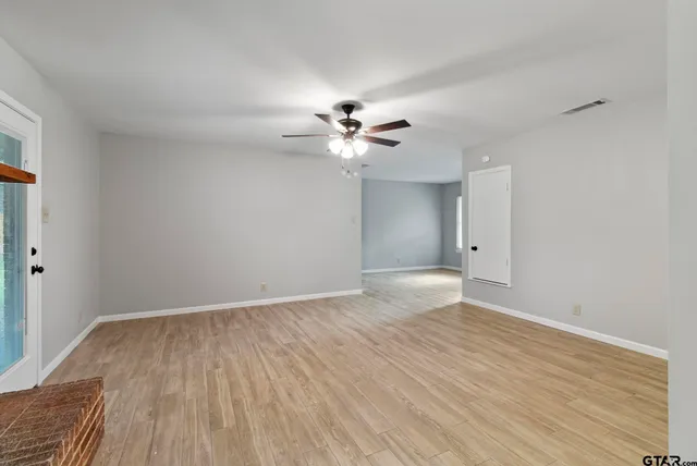 wooden floor in an empty room with a window