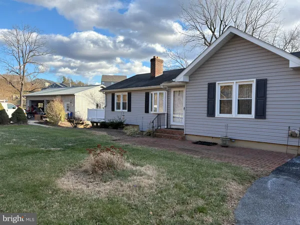 a view of an house with backyard space and garden