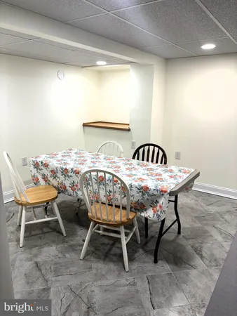 a kitchen with white cabinets and appliances