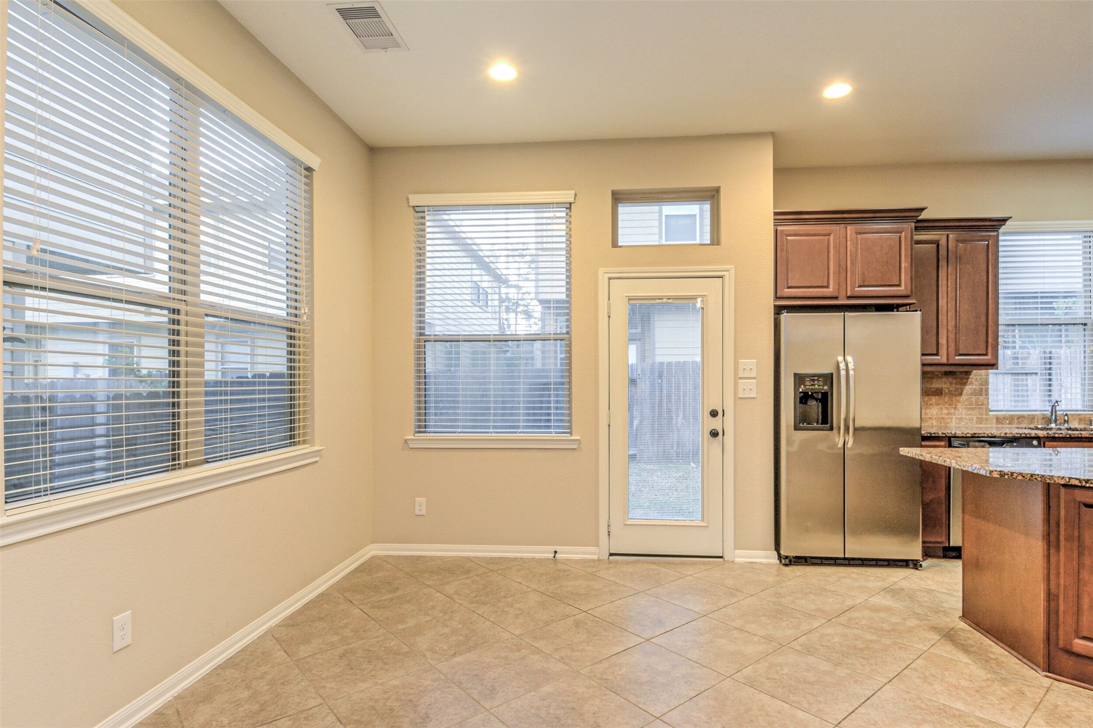19 Cheswood Manor Court The Woodlands, TX 77382 - Photo 14 of 37 an empty room with kitchen view and windows