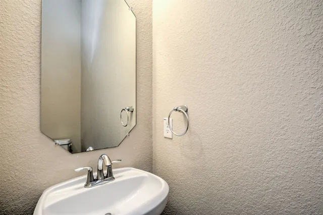 a bathroom with a sink and mirror