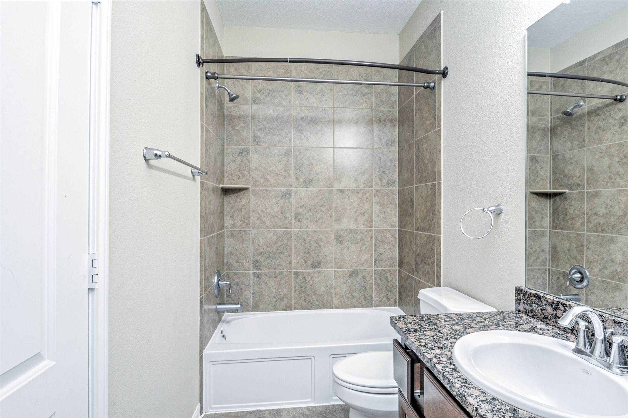 19 Cheswood Manor Court The Woodlands, TX 77382 - Photo 24 of 37 a bathroom with a granite countertop bathtub shower sink mirror vanity and toilet