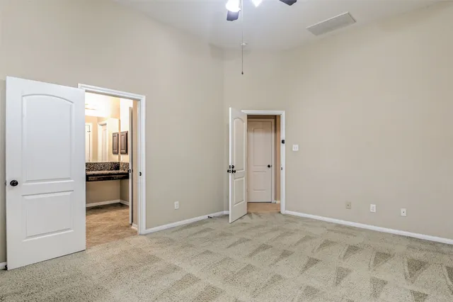 an empty room with closet and windows