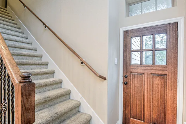 a view of staircase with wooden floor and a window
