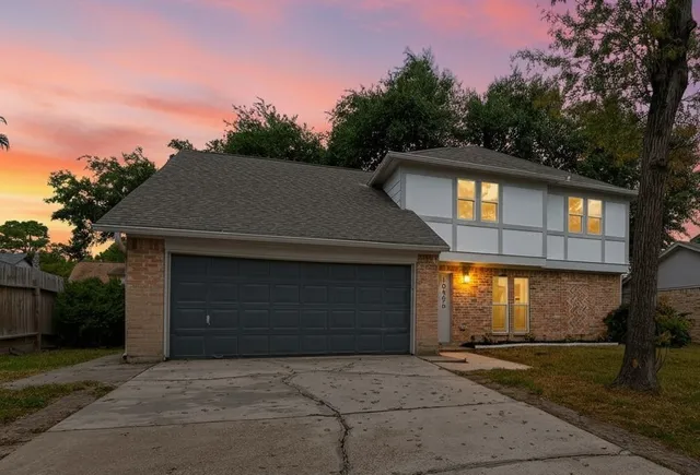 a front view of a house with yard garage and garage
