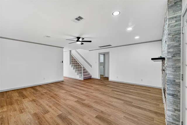 a view of an empty room with wooden floor
