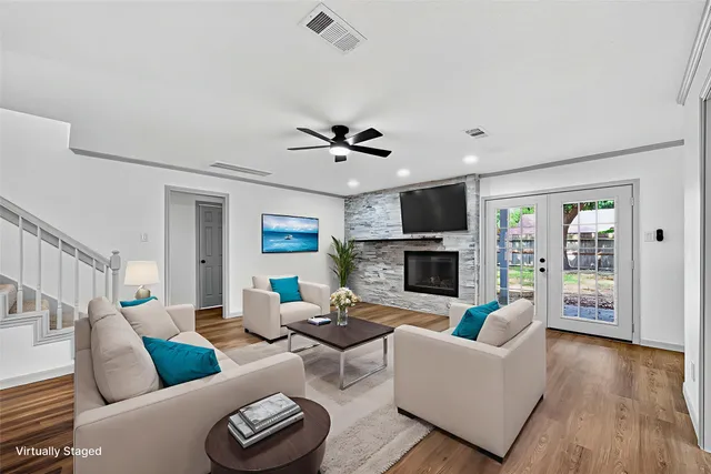 a living room with furniture a fireplace and a flat screen tv