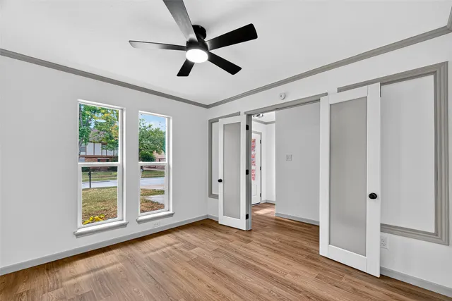 wooden floor in an empty room with a window