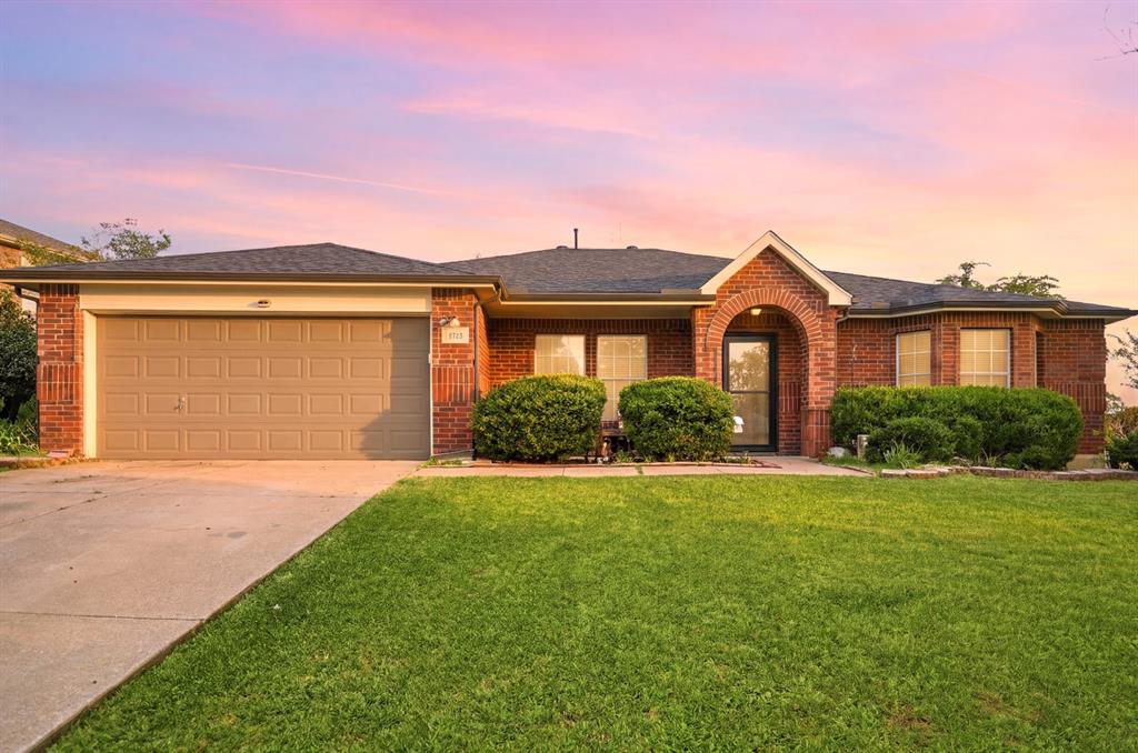 1213 Hampton Drive Forney, TX 75126 - Photo 1 of 27 a front view of a house with a yard and garage