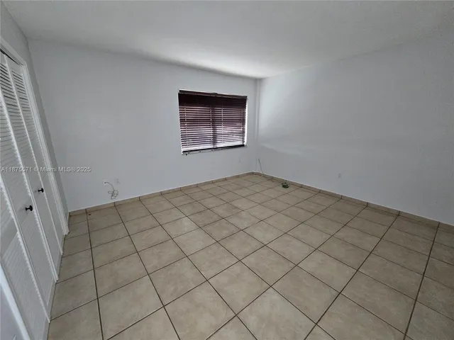 a view of an empty room and wooden floor