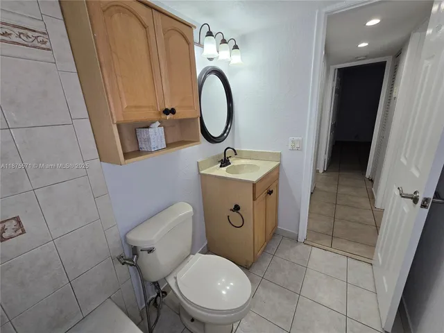 a view of bathroom with a sink and a mirror