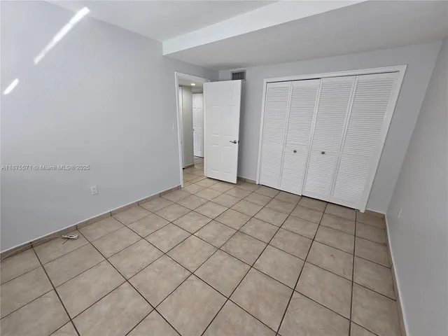 a kitchen with stainless steel appliances kitchen island granite countertop a sink and cabinets