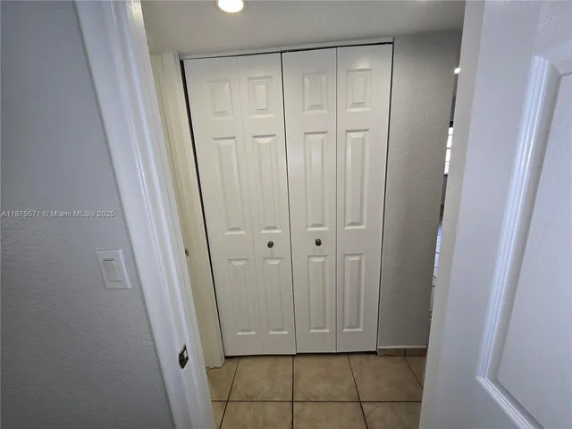 a kitchen with a sink a counter top space cabinets and a window