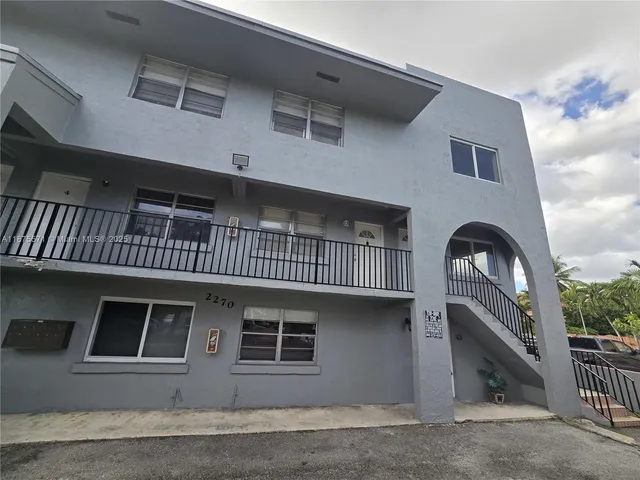 a kitchen with granite countertop a sink stove and cabinets