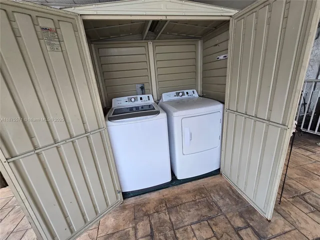 a kitchen with granite countertop a refrigerator and a stove