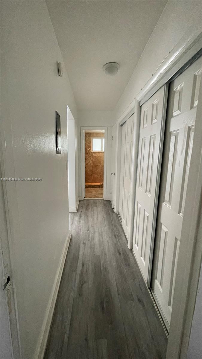 320 86th Street, Unit 3 Miami Beach, FL 33141 - Photo 11 of 13 a view of a hallway with wooden floor and staircase