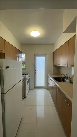 a kitchen with stainless steel appliances a refrigerator and a stove