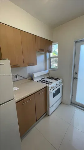 a kitchen with a stove and a refrigerator