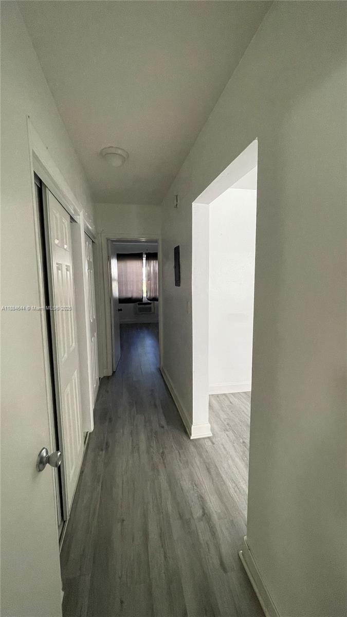 320 86th Street, Unit 3 Miami Beach, FL 33141 - Photo 8 of 13 a view of a hallway with wooden floor and stairs