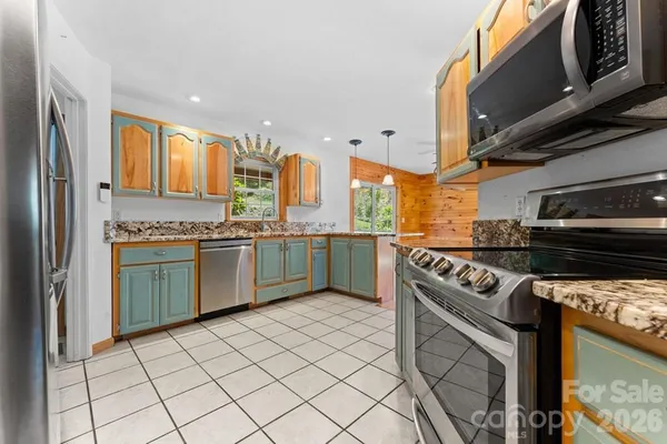 a kitchen with a stove sink and cabinets