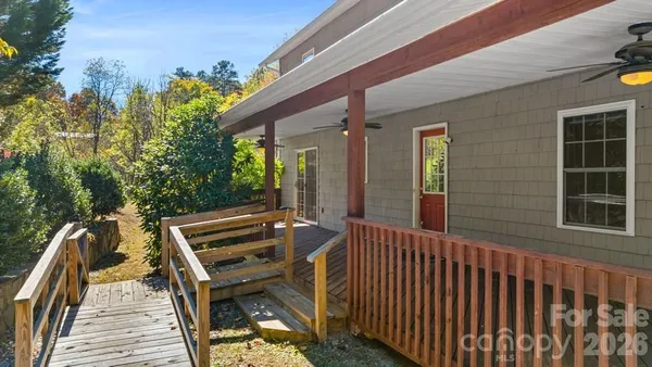 a view of a balcony with wooden floor and outdoor space